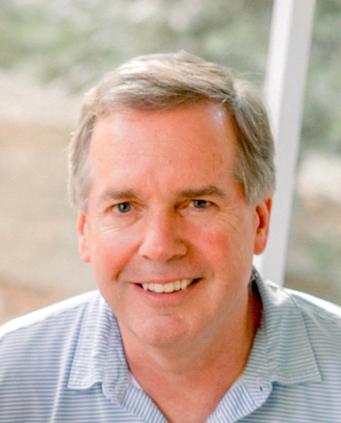 Bill Brazeal, smiling, in a light blue striped shirt